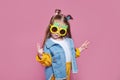 Summer fashion concept. cheerful little girl in big pineapple sunglasses on pink background Royalty Free Stock Photo