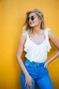 Summer, fashion and people concept - bright stylish portrait pretty woman in sunglasses against colorful wall in the city Royalty Free Stock Photo