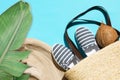 Summer fashion tropical concept. Women`s female beachwear straw hat wicker bag canvas striped shoes coconut green palm leaf Royalty Free Stock Photo