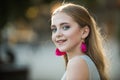 Summer fashion woman. Pretty girl with fashionable hair and pink earrings. Beautiful female. Beauty and fashion look of Royalty Free Stock Photo