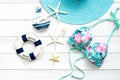 Summer Fashion woman swimsuit Bikini, camera, starfish, sunblock, sun glasses, blue hat. Travel and vacations in the holiday.