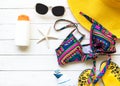 Summer Fashion woman yellow big hat and accessories in the beach. Tropical sea.Unusual top view, wood white background. Royalty Free Stock Photo