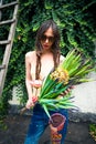 Summer fashion young woman with sunglasses and bouquet of flower Royalty Free Stock Photo