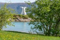 Summer feeling with green grass close to the beach and white monument