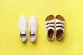 Summer female shoes - sandals birkenstock and leather sneakers on yellow background with copy space. Top view. Minimal Royalty Free Stock Photo