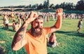 Summer fest. Hipster in cap happy celebrate event fest or festival. Man bearded hipster in front of crowd. Open air Royalty Free Stock Photo