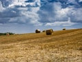 Summer Field with Hay Bales. under storm clouds.Agriculture Concept Royalty Free Stock Photo