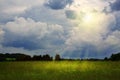 Summer field and sunset with rain clouds. Royalty Free Stock Photo