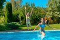 Summer fitness, kids in swimming pool have fun, smiling girls splash in water Royalty Free Stock Photo