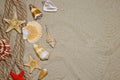 Summer flat composition with seashells, rope, sand beach and space for text on sandy background