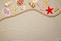 Summer flat composition with seashells, rope, sand beach and space for text on sandy background Royalty Free Stock Photo