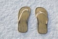 Summer flip flop sandals on the white snow Royalty Free Stock Photo