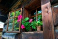 Summer flowers in the log cabin window