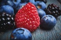 Close up fresh raspberrie, blueberries and blackberryes on a dark background Royalty Free Stock Photo