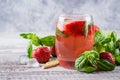 Summer Food and Drink. Strawberry lemonade with basil in glass on wooden background