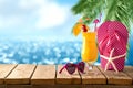 Summer fresh cocktail on wooden board over sea beach background. Holidays vacation concept