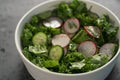 Summer fresh salad with radish, cucumber and herbs in white bowl Royalty Free Stock Photo