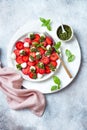 Summer fruit caprese salad with strawberries. Strawberry salad with basil pesto and mozzarella.