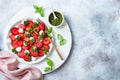 Summer fruit caprese salad with strawberries. Strawberry salad with basil pesto and mozzarella.