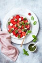 Summer fruit caprese salad with strawberries. Strawberry salad with basil pesto and mozzarella.
