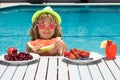 Summer fruit for children. Happy child playing in swimming pool. Portrait of summer kids. Summer kids vacation. Little Royalty Free Stock Photo