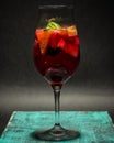 Summer fruit cocktail in glass , lemonade, studio photo, dark background