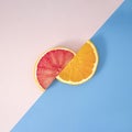 Summer fruit healthy orange and grapefruit party creative concept. Fresh slice on pastel blue and pink background Royalty Free Stock Photo