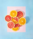 Summer fruit healthy orange and grapefruit party creative concept. Fresh slice on pastel blue and pink background. Royalty Free Stock Photo