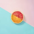 Summer fruit healthy orange and grapefruit party creative concept. Fresh slice on pastel blue and pink background Royalty Free Stock Photo