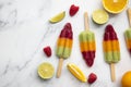 Summer fruit ice lollies made with orange lime and raspberries Royalty Free Stock Photo