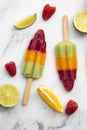 Summer fruit ice lollies made with orange lime and raspberries Royalty Free Stock Photo