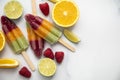 Summer fruit ice lollies made with orange lime and raspberries Royalty Free Stock Photo