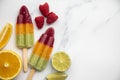 Summer fruit ice lollies made with orange lime and raspberries Royalty Free Stock Photo