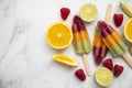Summer fruit ice lollies made with orange lime and raspberries Royalty Free Stock Photo