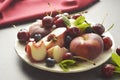 Summer fruit mix - cherry, blueberry, peach. Fruit salad plate. Flat lay with copy space Royalty Free Stock Photo