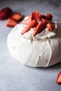 Summer fruit pavlova - famous Australian dessert from baked whipped egg whites and cream cheese filling with strawberries