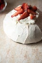 Summer fruit pavlova - famous Australian dessert from baked whipped egg whites and cream cheese filling with strawberries