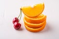 Summer fruit two cherries with stacked oranges on white background Royalty Free Stock Photo