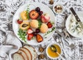 Summer fruits - apricots, peaches, plums, cherries, strawberries and blue cheese, honey, walnuts on a light stone background. Heal Royalty Free Stock Photo