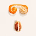 Summer fruits as face from tangerine and red orange. Creative citrus fruit food flat lay in minimal style