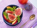 Summer fruits with mint leaves upon violet napkin in a vase. Fruit salad. Assorted summer fruits. Healthy eating concept.