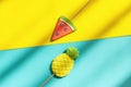 Summer fruits pineapple and watermelon lollipops on stick on blue yellow background with hard light and shadow. Concept Royalty Free Stock Photo