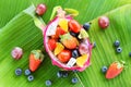 Summer fruits tropical on banana leaf background - Fruit salad bowl served in a dragon fruit and vegetables healthy organic food Royalty Free Stock Photo