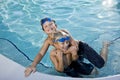 Summer fun, boys playing in swimming pool