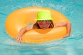 Summer fun. Child boy swim with floating ring in swimming pool. Kids summer vacation. Happy little boy with inflatable Royalty Free Stock Photo