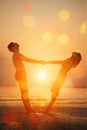 Summer fun holyday on beach background. A loving young couple hugging and kissing on the beach at sunset. Two lovers, man and Royalty Free Stock Photo