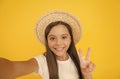 Summer fun. teen girl greeting summer. little beauty in straw hat make selfie. beach style for kids. happy summer