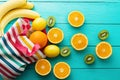 Summer fun time and fruits on blue wooden background. Mock up and picturesque. Orange, lemon, kiwi, banana fruit on table. Royalty Free Stock Photo