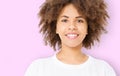 Summer fun time. Portrait of young beautiful brunette dark skinned woman with curly hair isolated on pink background. Girl smile