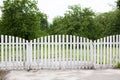 Summer garden in backyard and wooden fence. Wooden Fence Solid Privacy in rustic style. Long country style garden fence in country
